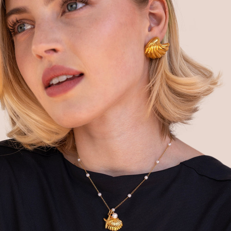 Anneliese – Goldene Ohrstecker in Muschelform.